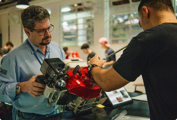 Pessoas mexendo em motor em laboratório de automação do Instituto Mauá de Tecnologia
